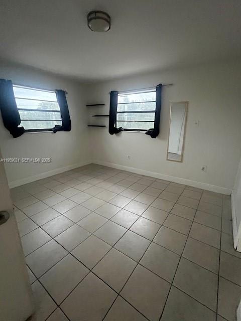 6780 Southwest 44th Street, Unit 16 Miami, FL 33155 - Photo 6 of 9 a view of an empty room and window