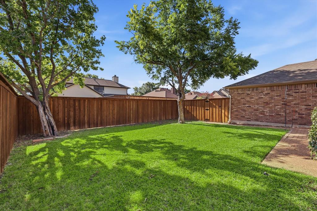 318 Lodge Road Coppell, TX 75019 - Photo 35 of 35 A generous, fully fenced backyard offers mature shade trees and ample space for play.