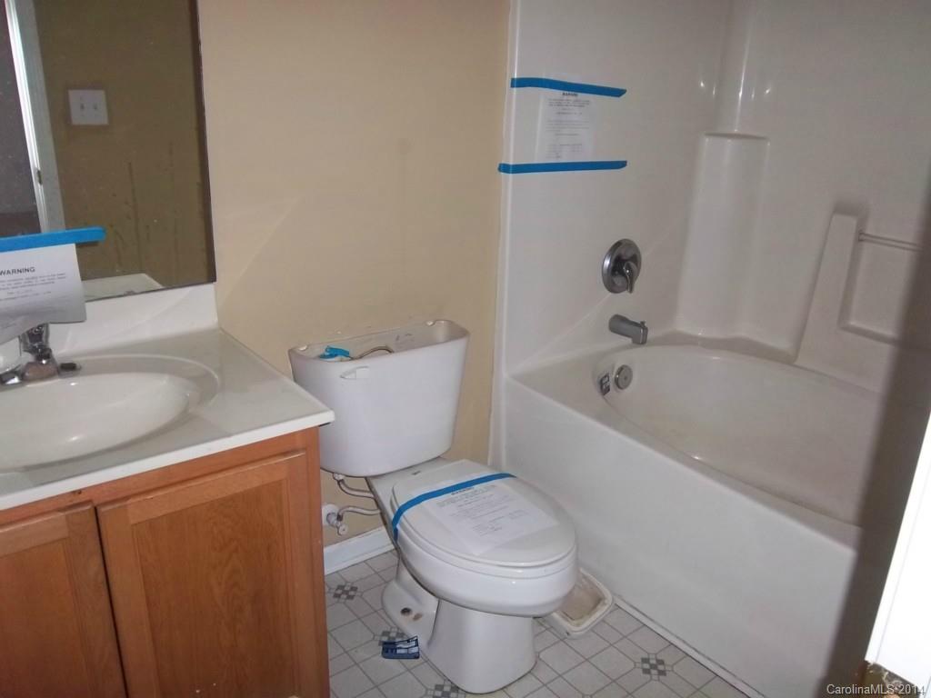 814 Mt Holly-Huntersville Road Charlotte, NC 28214 - Photo 11 of 13 a white toilet sitting next to a bath tub