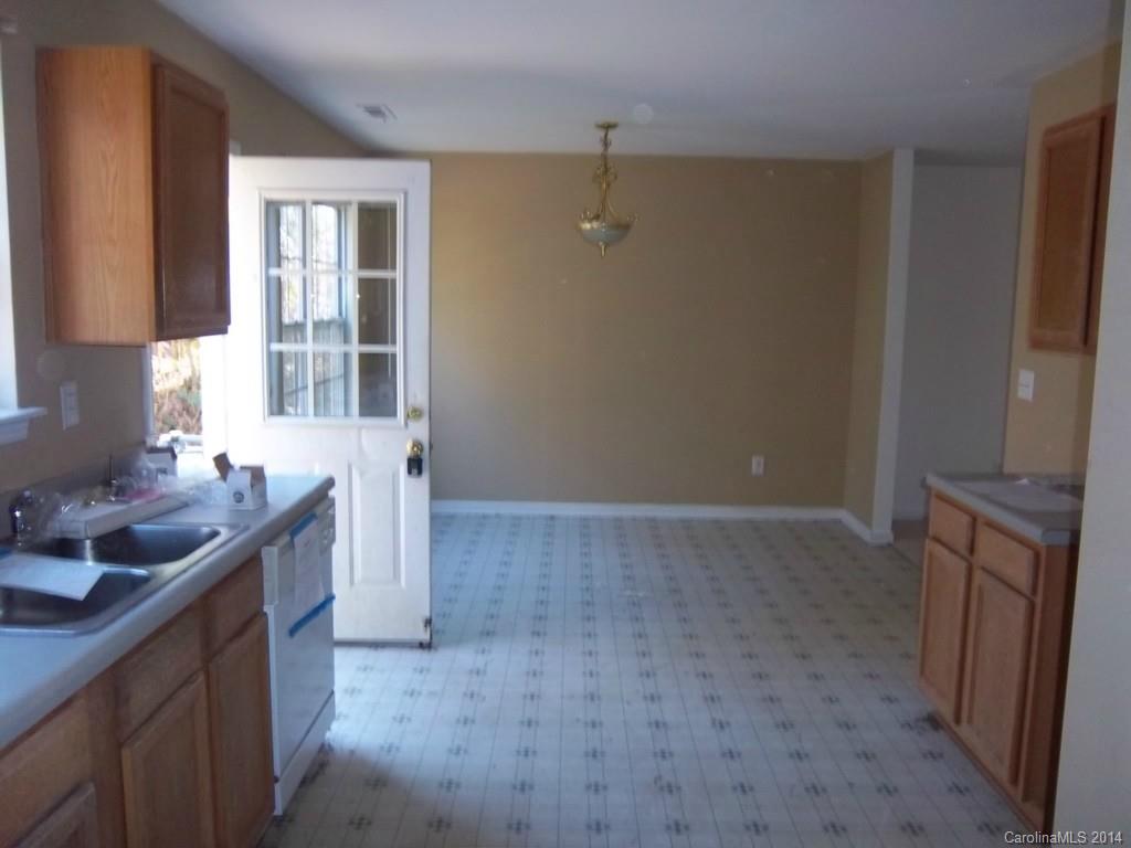 814 Mt Holly-Huntersville Road Charlotte, NC 28214 - Photo 4 of 13 a kitchen with a sink stove and cabinets