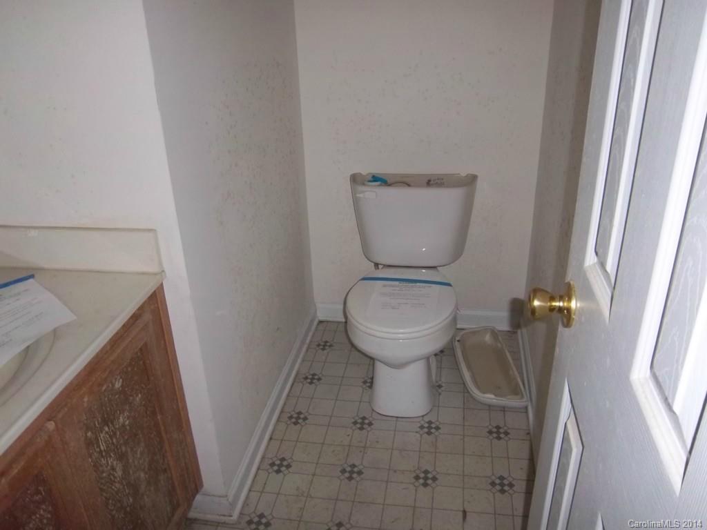 814 Mt Holly-Huntersville Road Charlotte, NC 28214 - Photo 5 of 13 a white toilet sitting next to a sink