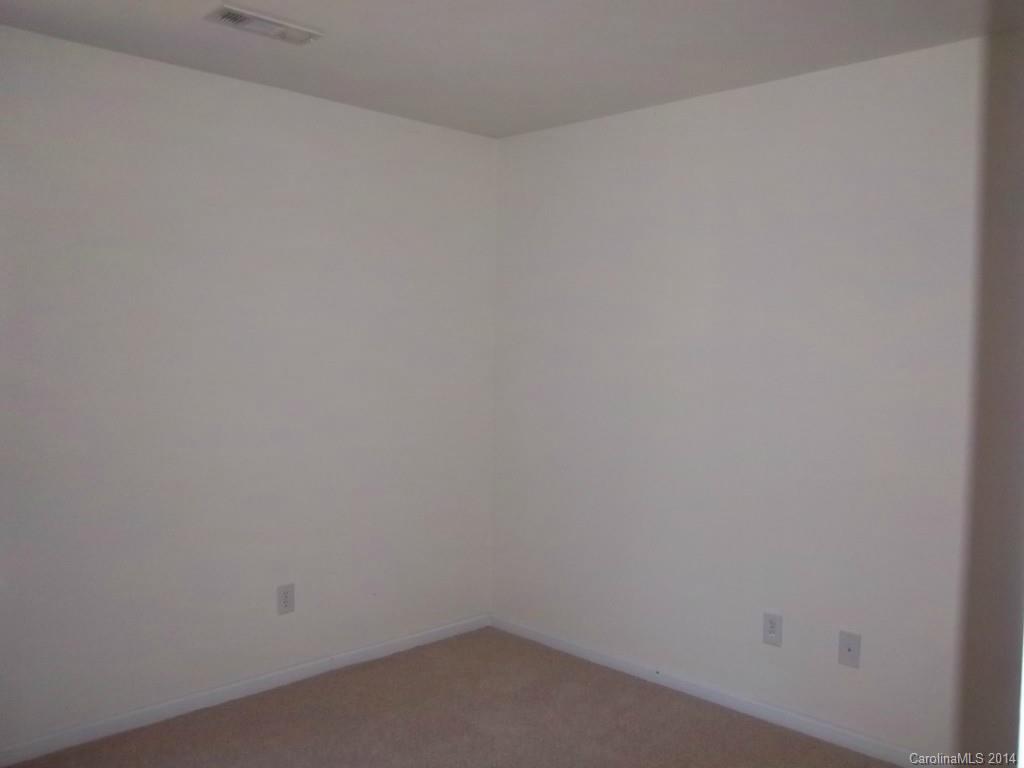 814 Mt Holly-Huntersville Road Charlotte, NC 28214 - Photo 7 of 13 a room that has a white wall