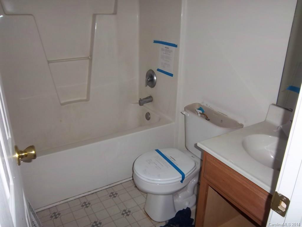 814 Mt Holly-Huntersville Road Charlotte, NC 28214 - Photo 8 of 13 a bathroom with a sink a toilet and tub