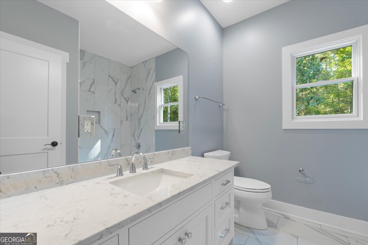 1750 Reids Ferry Road Buckhead, GA 30625 - Photo 13 of 57 a bathroom with a granite countertop sink a toilet and a mirror