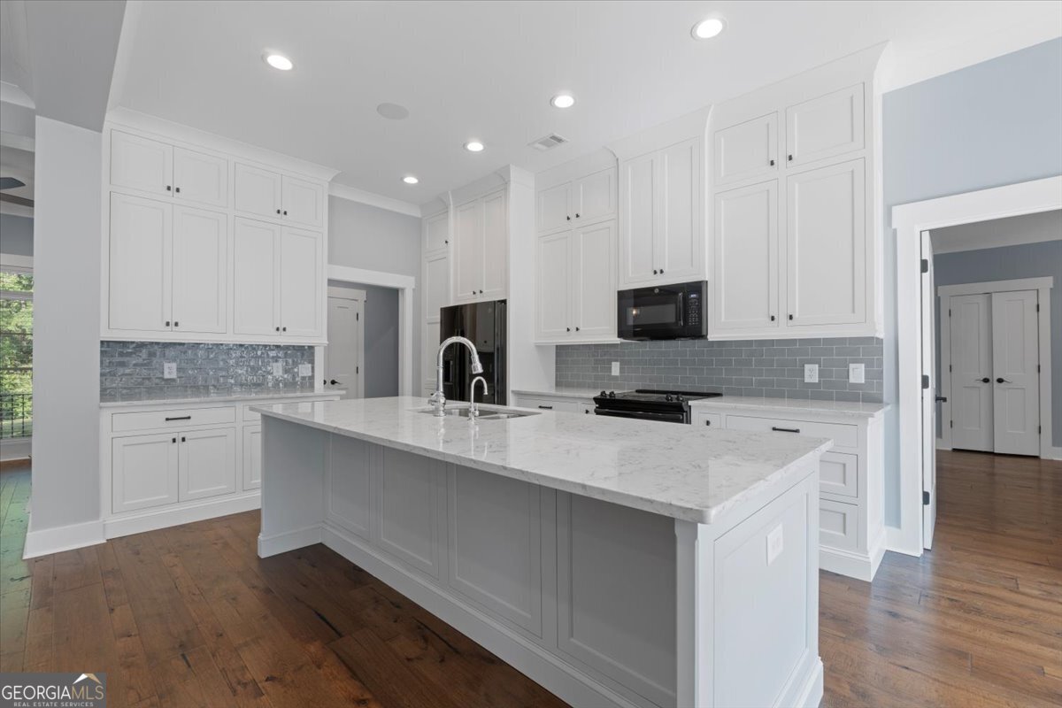 1750 Reids Ferry Road Buckhead, GA 30625 - Photo 19 of 57 a kitchen with white cabinets and stainless steel appliances