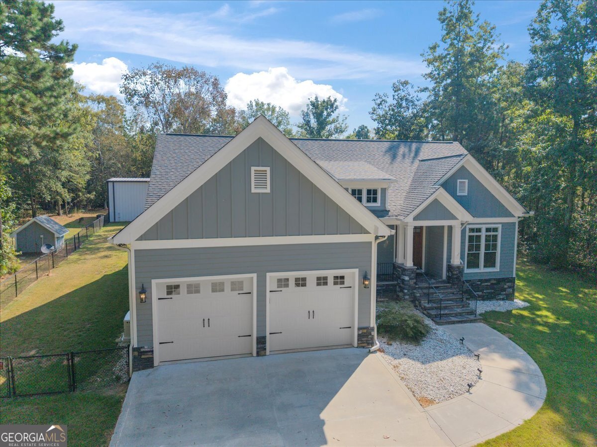 1750 Reids Ferry Road Buckhead, GA 30625 - Photo 3 of 57 a house with trees in the background