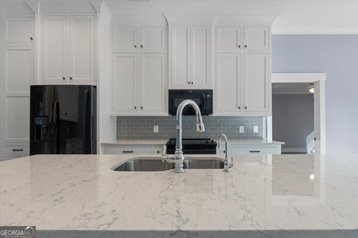 1750 Reids Ferry Road Buckhead, GA 30625 - Photo 7 of 57 a kitchen with granite countertop a sink and a stove