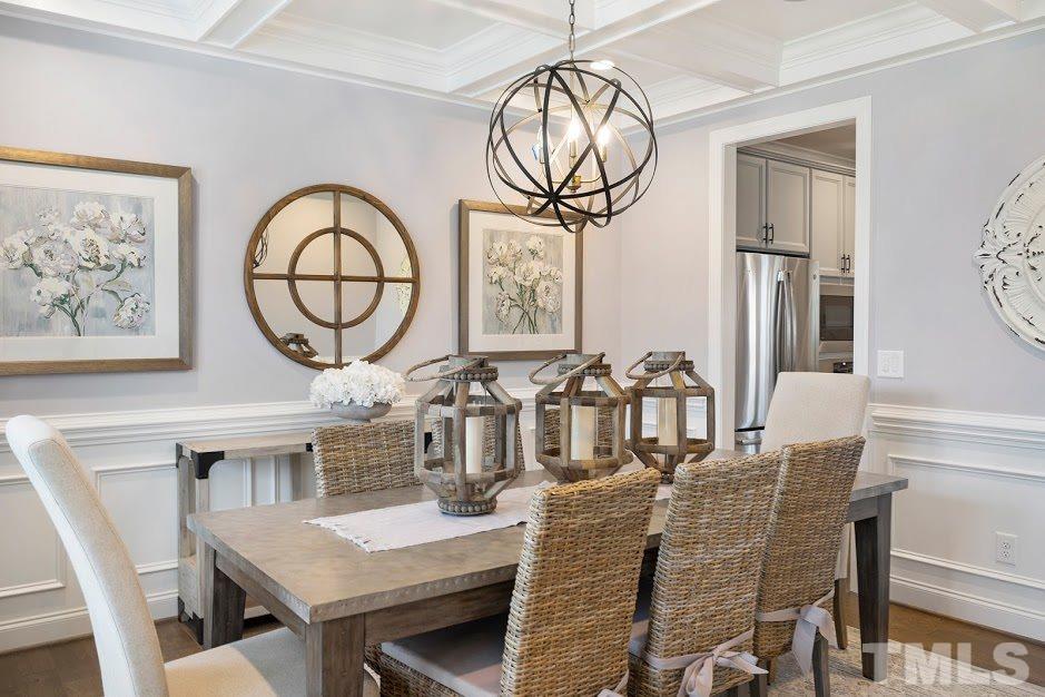 7749 Wilderness Road Raleigh, NC 27613 - Photo 1 of 1 a dining room with furniture and window