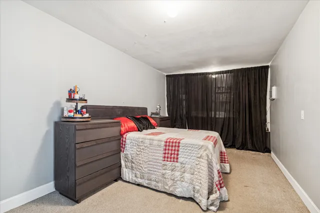 a bedroom with a bed and a dresser