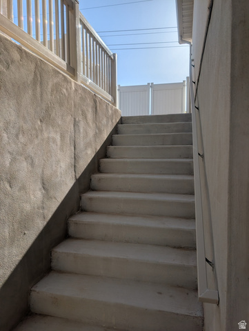 3831 South Powderwood Lane, Unit 111 Mapleton, UT 84664 - Photo 12 of 12 Exterior concrete staircase featuring a privacy fence and a white baluster railing