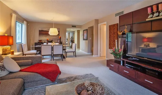 a living room with furniture gym equipment and a flat screen tv