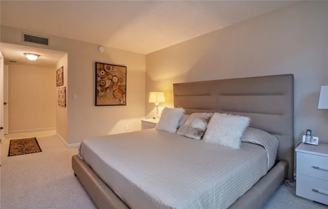 a bedroom with a bed and a lamp