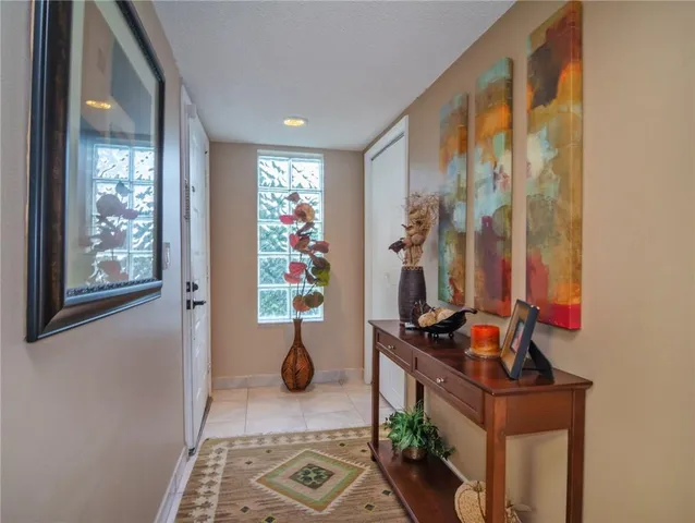 a view of hallway with furniture and a window