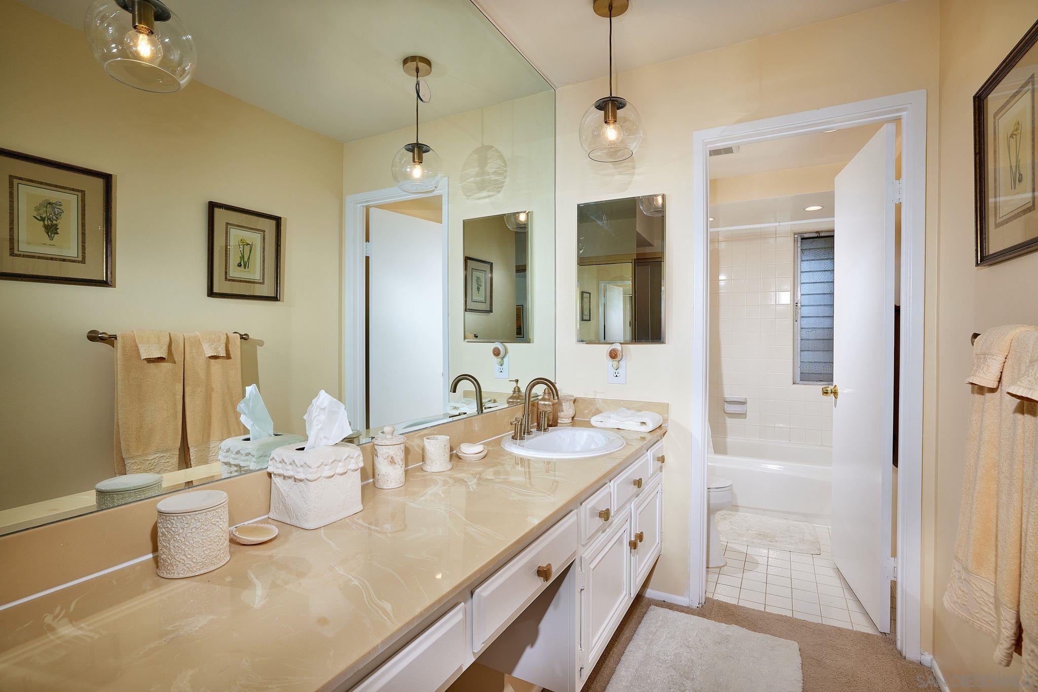 2035 Caminito Circulo Sur La Jolla, CA 92037 - Photo 16 of 22 a bathroom with a granite countertop sink and a mirror