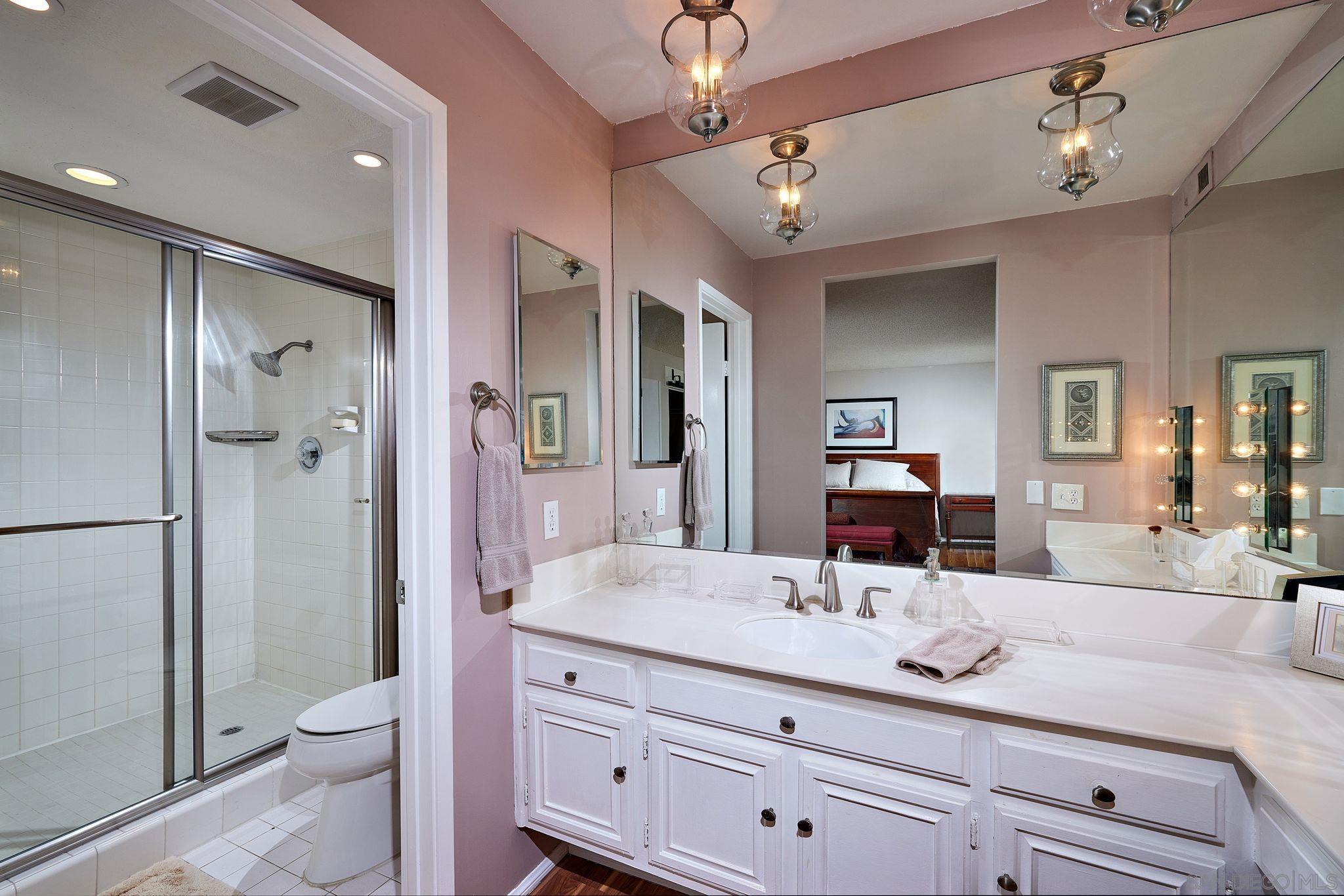 2035 Caminito Circulo Sur La Jolla, CA 92037 - Photo 19 of 22 a bathroom with a granite countertop sink a toilet a mirror and shower