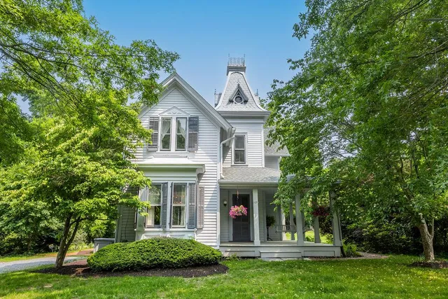 a front view of a house with a garden