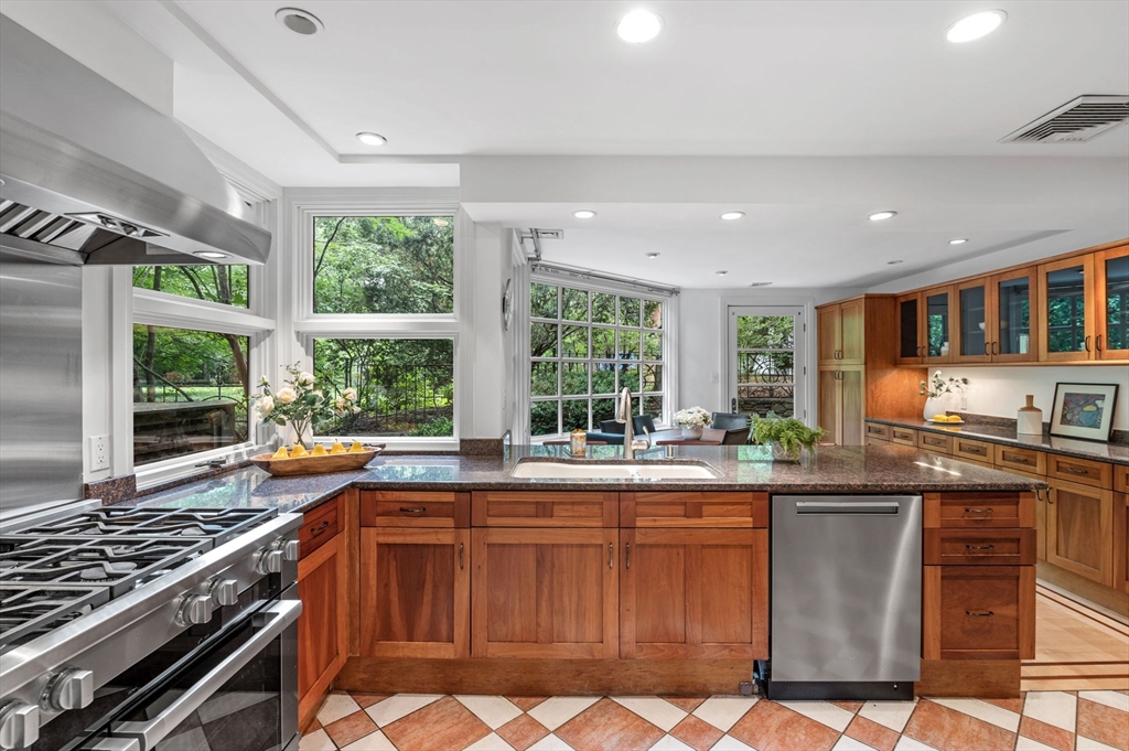 18 Hemlock Road Cambridge, MA 02138 - Photo 16 of 26 a kitchen with stainless steel appliances granite countertop a stove a sink dishwasher and a refrigerator