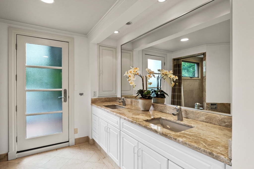 18 Hemlock Road Cambridge, MA 02138 - Photo 18 of 26 a bathroom with a double vanity sink and a mirror