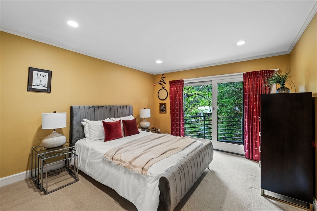 18 Hemlock Road Cambridge, MA 02138 - Photo 21 of 26 a bedroom with a bed and wooden floor