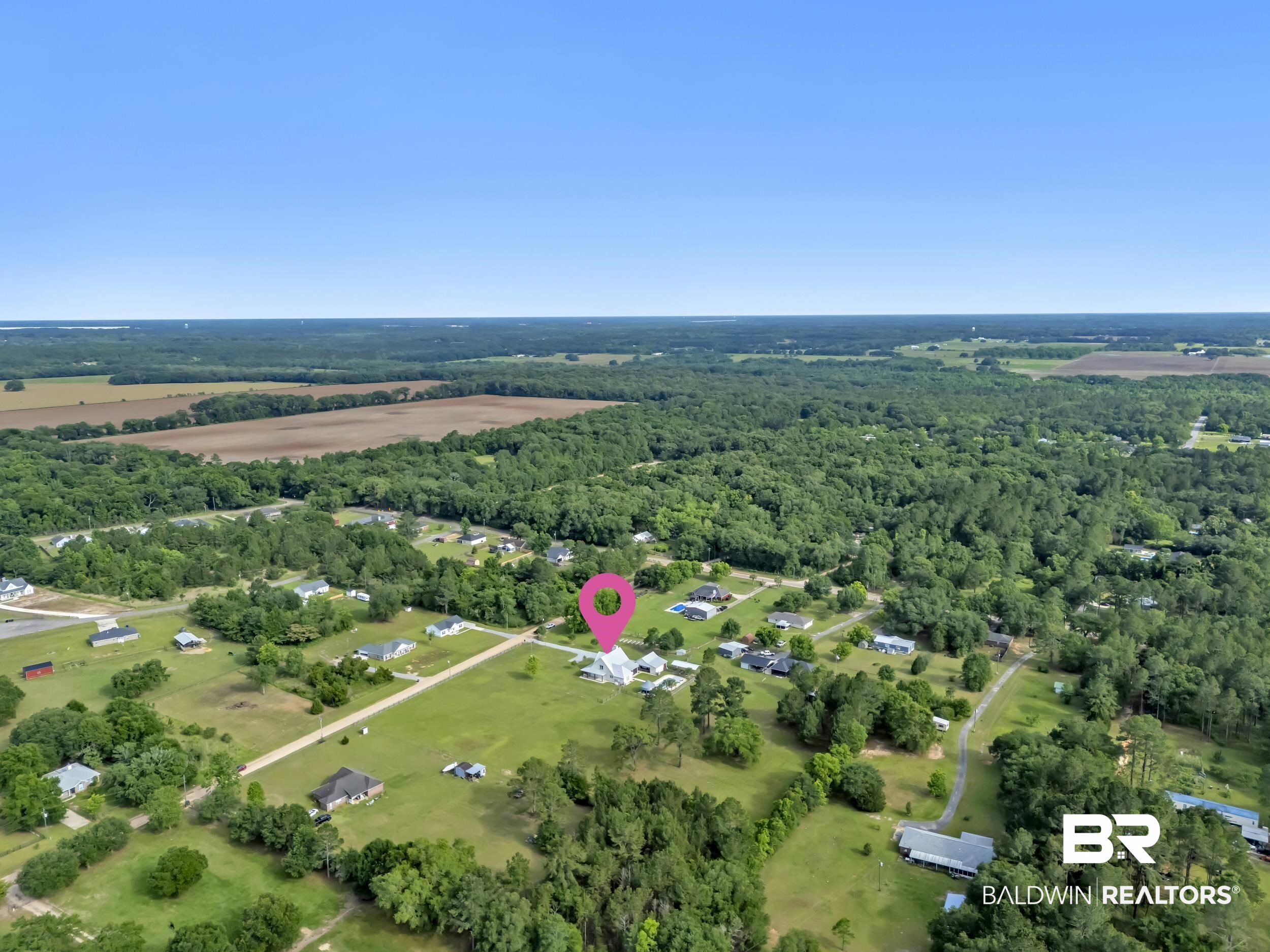 6576 Ranch Loop Road East Grand Bay, AL 36541 - Photo 36 of 39 Aerial perspective showcasing expansive green spaces, surrounding woodlands, and a clear blue sky