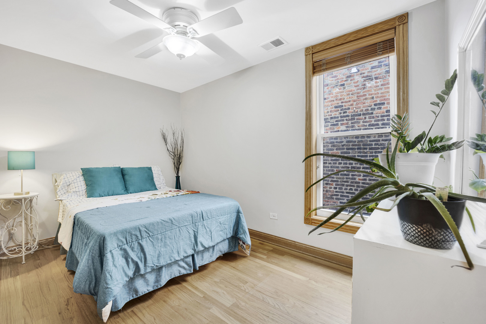 839 South Laflin Street, Unit 3 Chicago, IL 60607 - Photo 17 of 21 a bedroom with a bed and a chandelier