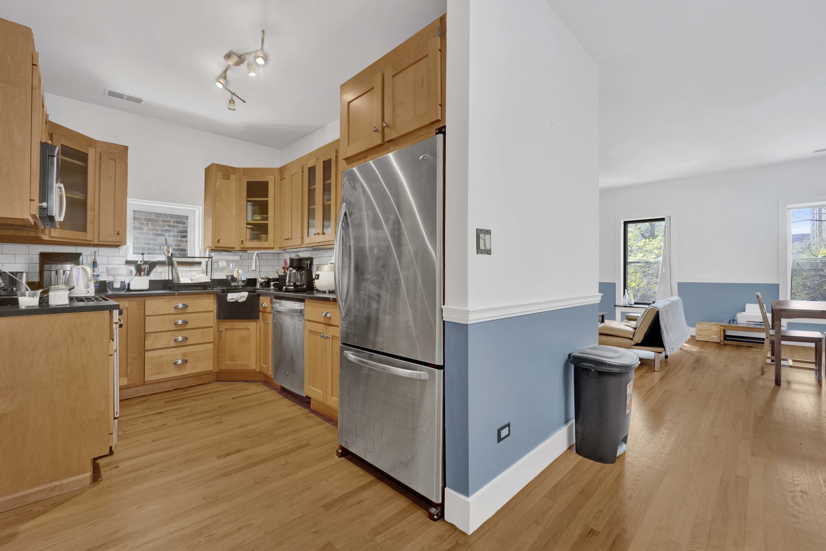 839 South Laflin Street, Unit 3 Chicago, IL 60607 - Photo 8 of 21 a kitchen with granite countertop a refrigerator a stove top oven a sink dishwasher and white cabinets with wooden floor