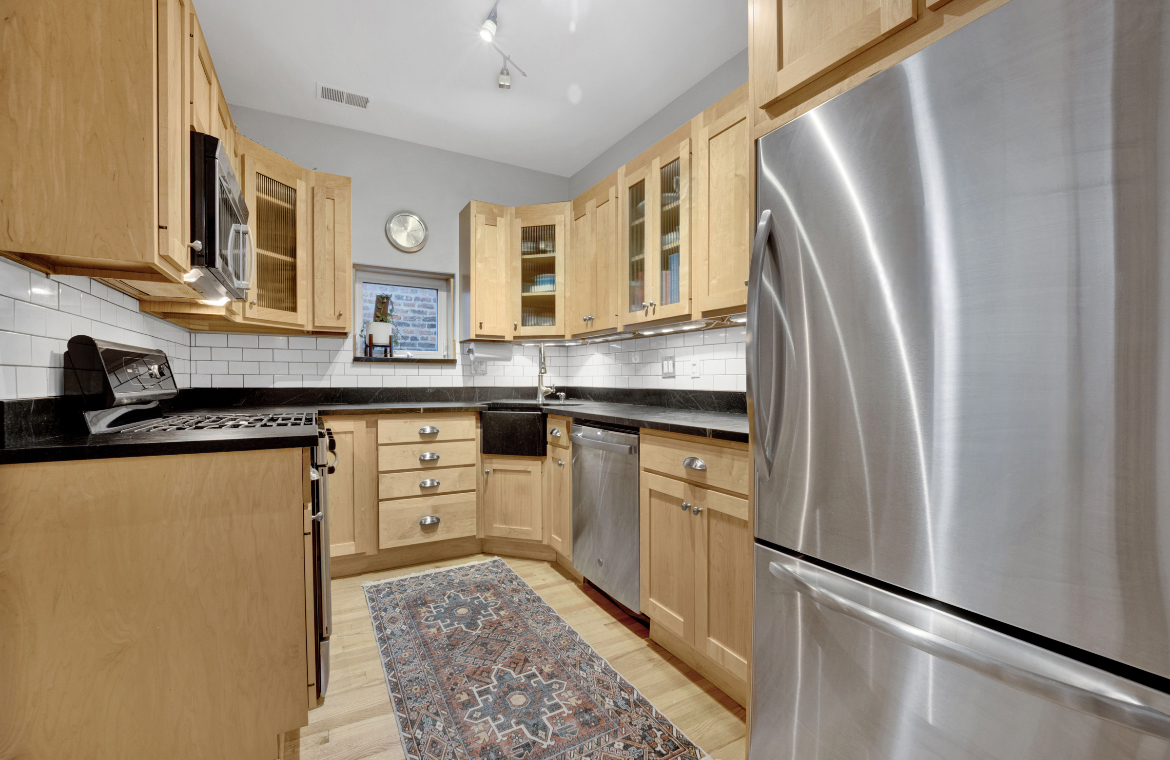 839 South Laflin Street, Unit 3 Chicago, IL 60607 - Photo 9 of 21 a kitchen with stainless steel appliances granite countertop a refrigerator a sink dishwasher a stove with white cabinets and wooden floor