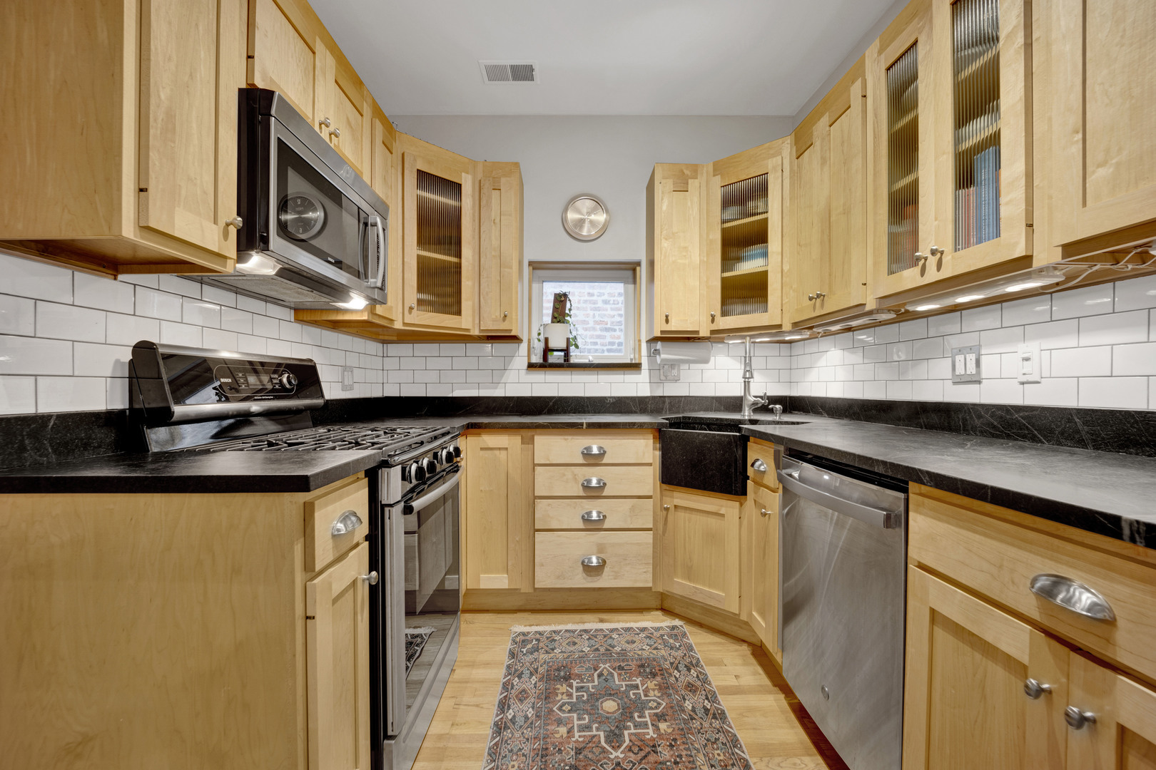839 South Laflin Street, Unit 3 Chicago, IL 60607 - Photo 10 of 21 a kitchen with stainless steel appliances granite countertop a sink and cabinets