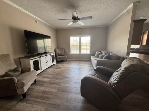 a room with a bed and a view of kitchen