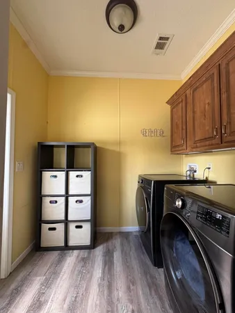 a bedroom with a bed flat screen tv and a window