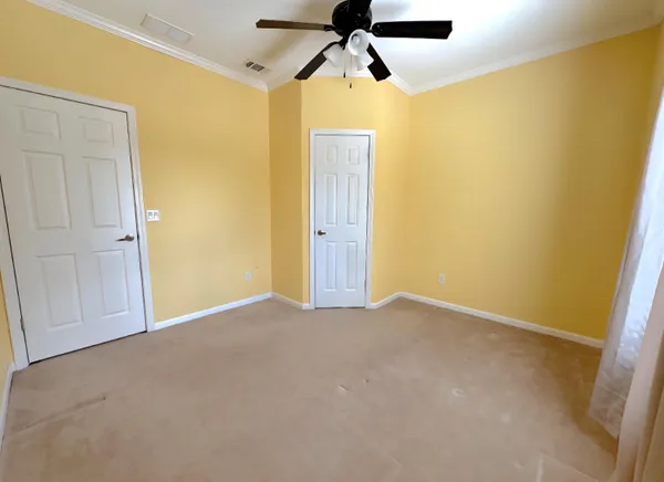 a living room with a bed furniture and a window