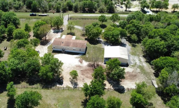 an aerial view of a house with a yard