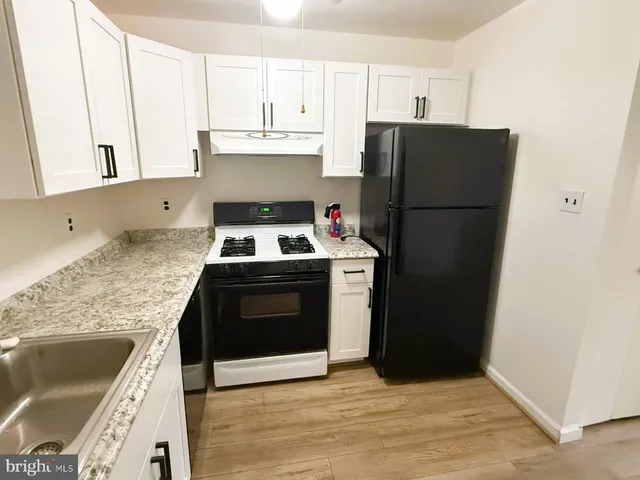 a kitchen with a refrigerator sink and stove