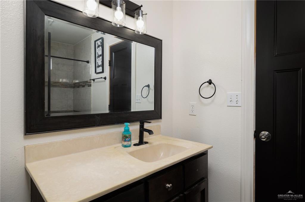 4204 Lott Road Donna, TX 78537 - Photo 9 of 15 a bathroom with a sink and a mirror