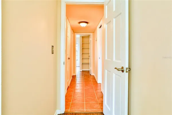 a view of a hallway with wooden floor and glass door
