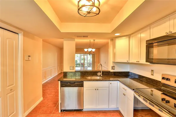 a kitchen with stainless steel appliances granite countertop a sink and cabinets