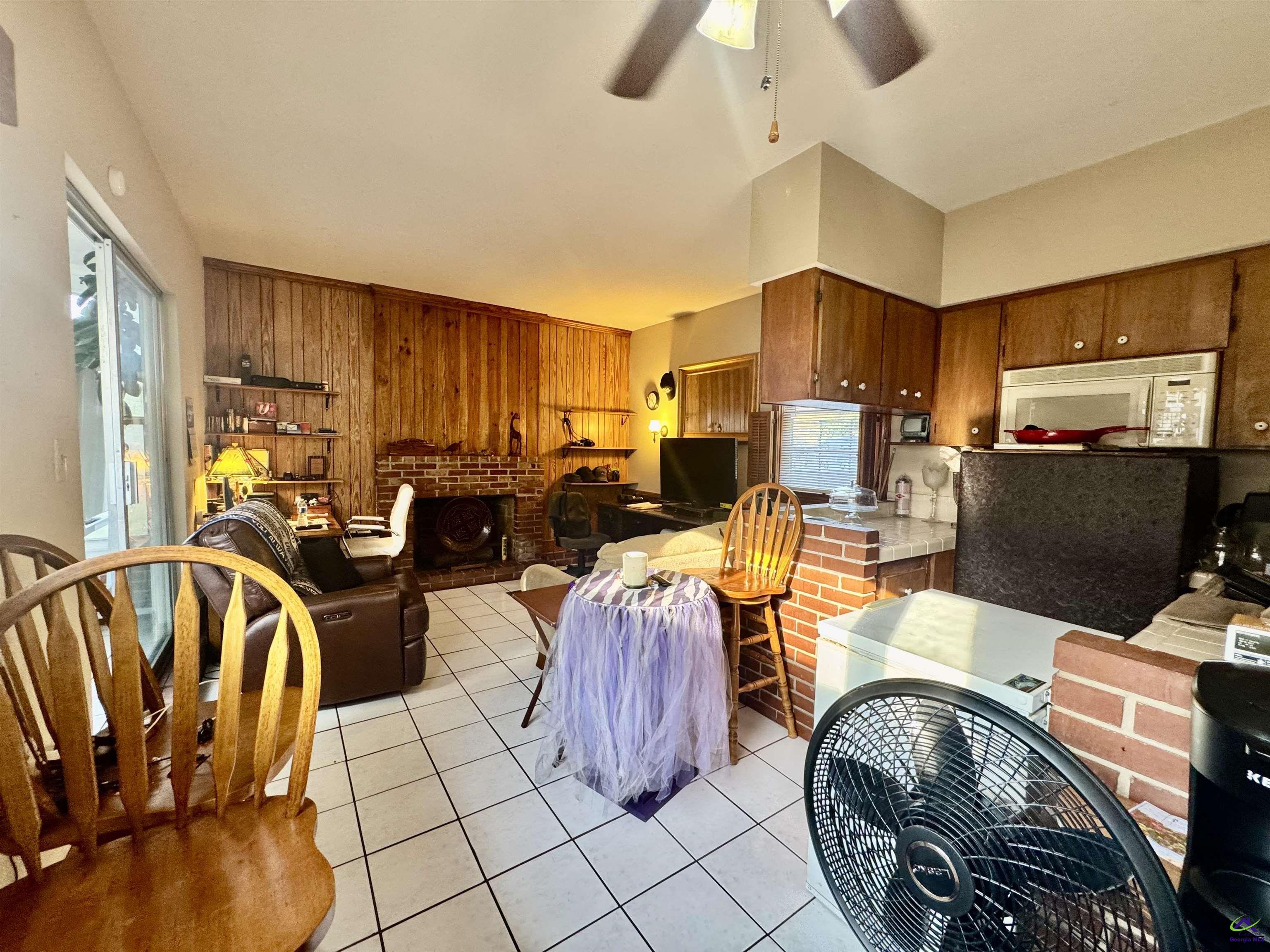 914 Adderton Street Americus, GA 31719 - Photo 44 of 53 a living room with furniture a flat screen tv and kitchen view