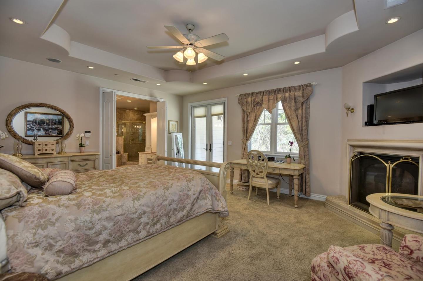 22219 Summit Road Los Gatos, CA 95033 - Photo 15 of 34 a living room with furniture a fireplace and a flat screen tv