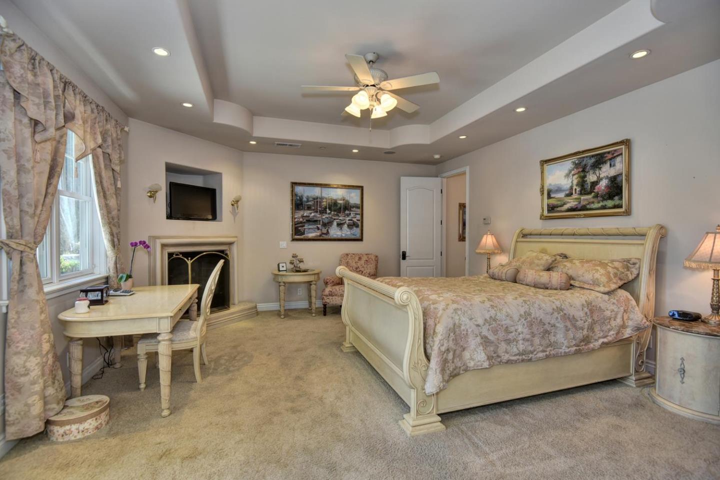 22219 Summit Road Los Gatos, CA 95033 - Photo 16 of 34 a spacious bedroom with a bed and a chandelier