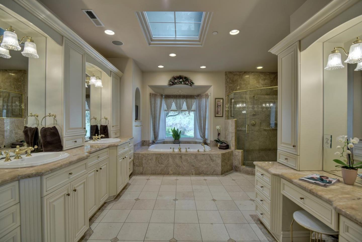 22219 Summit Road Los Gatos, CA 95033 - Photo 17 of 34 a bathroom with a granite countertop sink a toilet a mirror and shower