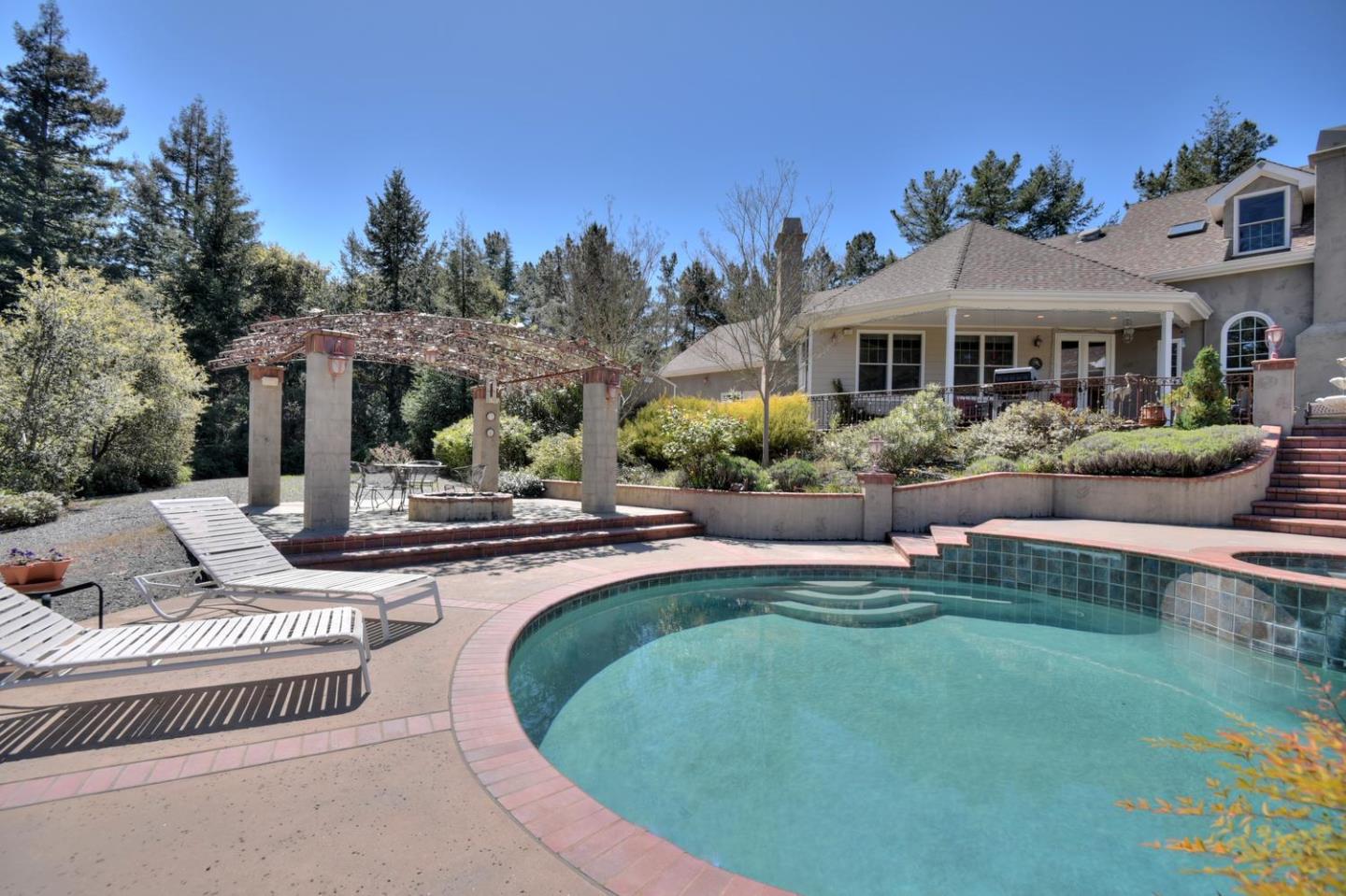 22219 Summit Road Los Gatos, CA 95033 - Photo 23 of 34 a view of a house with backyard sitting area and swimming pool