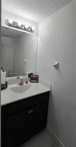 a white toilet sitting next to a white sink