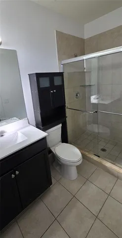 a bathroom with a sink a toilet a mirror and vanity