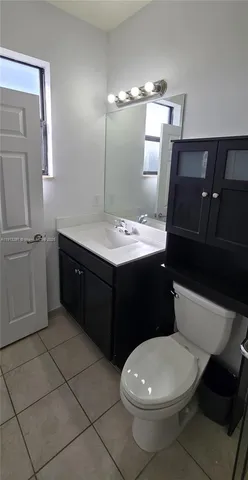 a white toilet sitting next to a bathroom sink