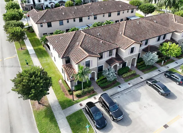 an aerial view of a house with garden space and street view