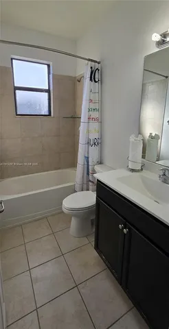 a bathroom with a sink vanity mirror and toilet