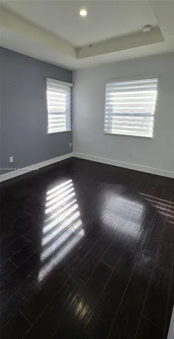 an empty room with wooden floor and closet