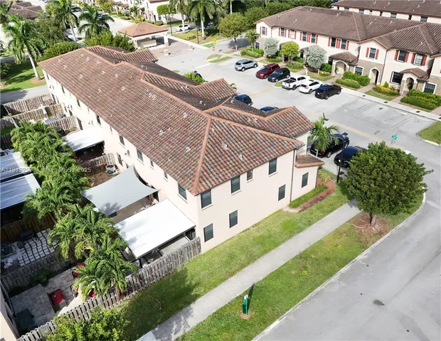 an aerial view of houses with yard