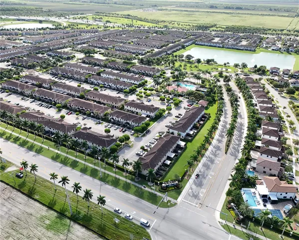 an aerial view of a residential houses with outdoor space and river