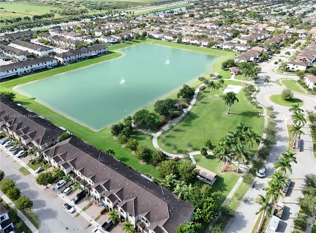 an aerial view of a house with a yard and swimming pool